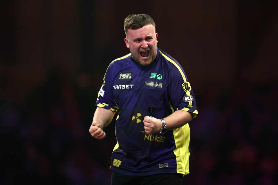 Luke Littler celebrates a darts victory.