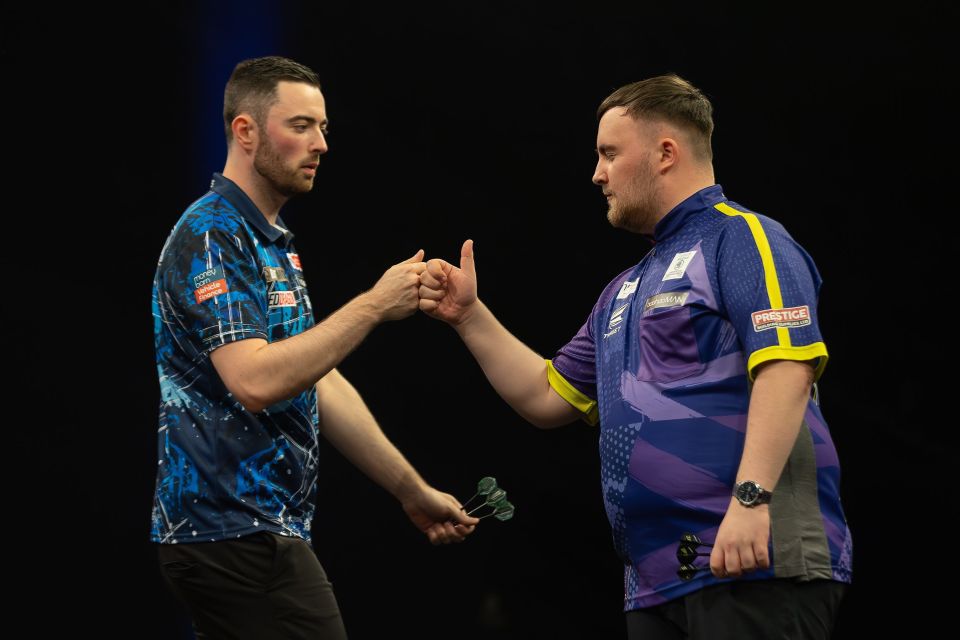 Luke Littler and Luke Humphries fist-bumping at the Premier League Darts Finals.