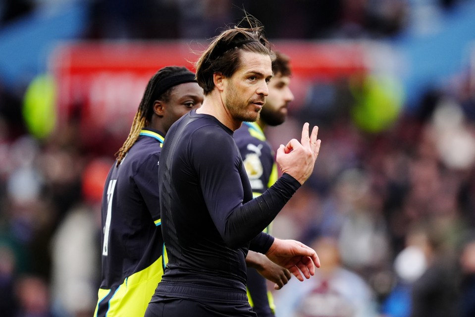 Jack Grealish makes an "OK" gesture to the crowd.