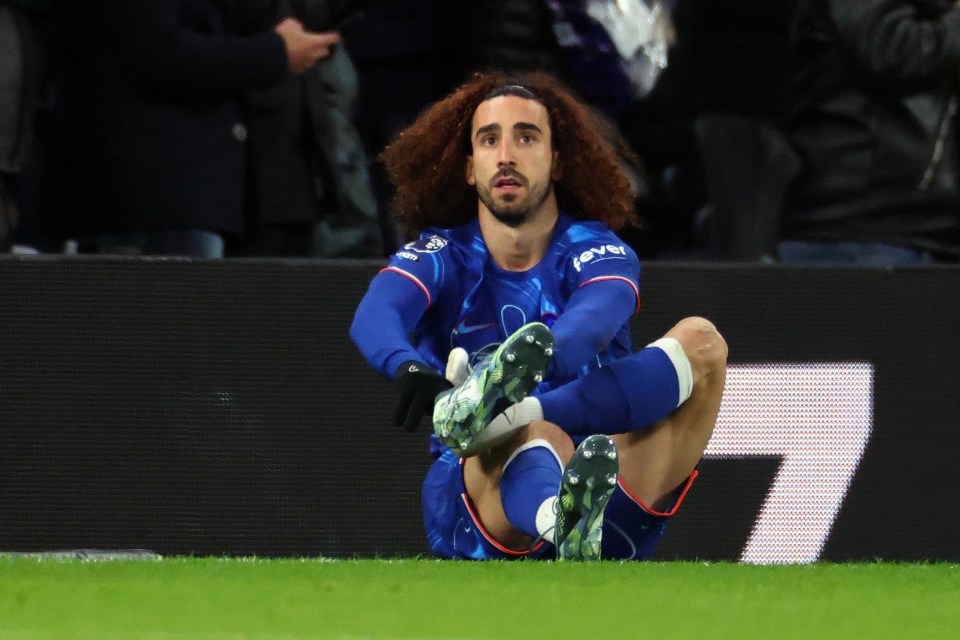 Marc Cucurella of Chelsea retrieving his boots on the field.