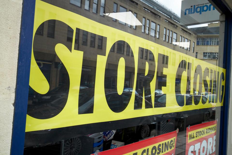 Store closing sign in shop window.