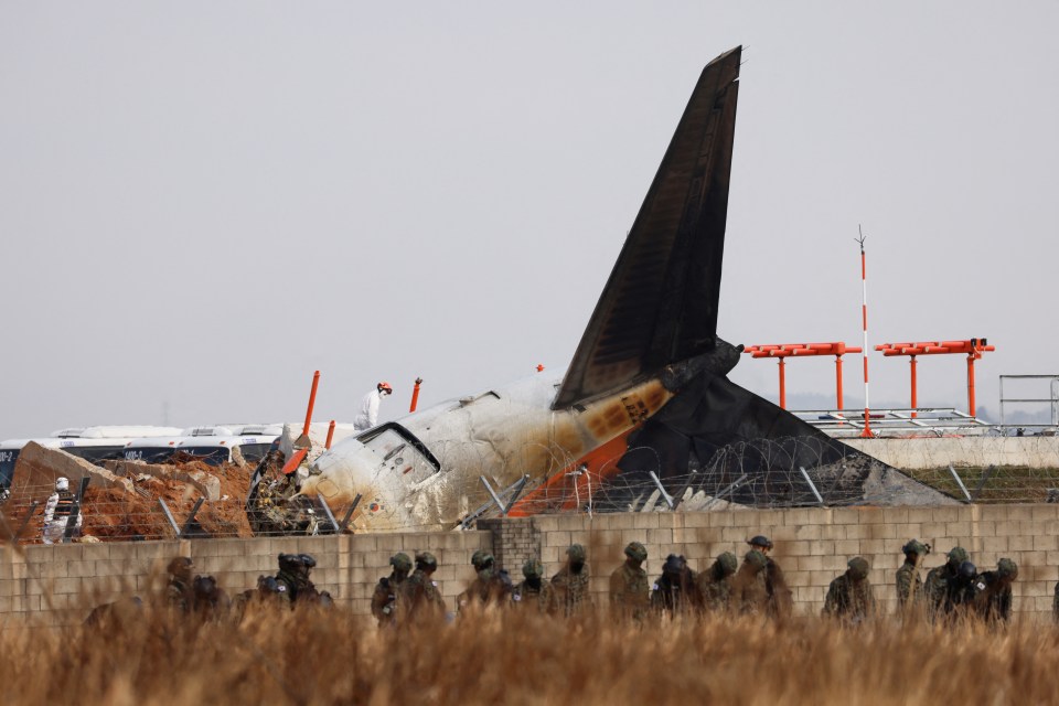 Military personnel at the site of a plane crash at Muan International Airport.