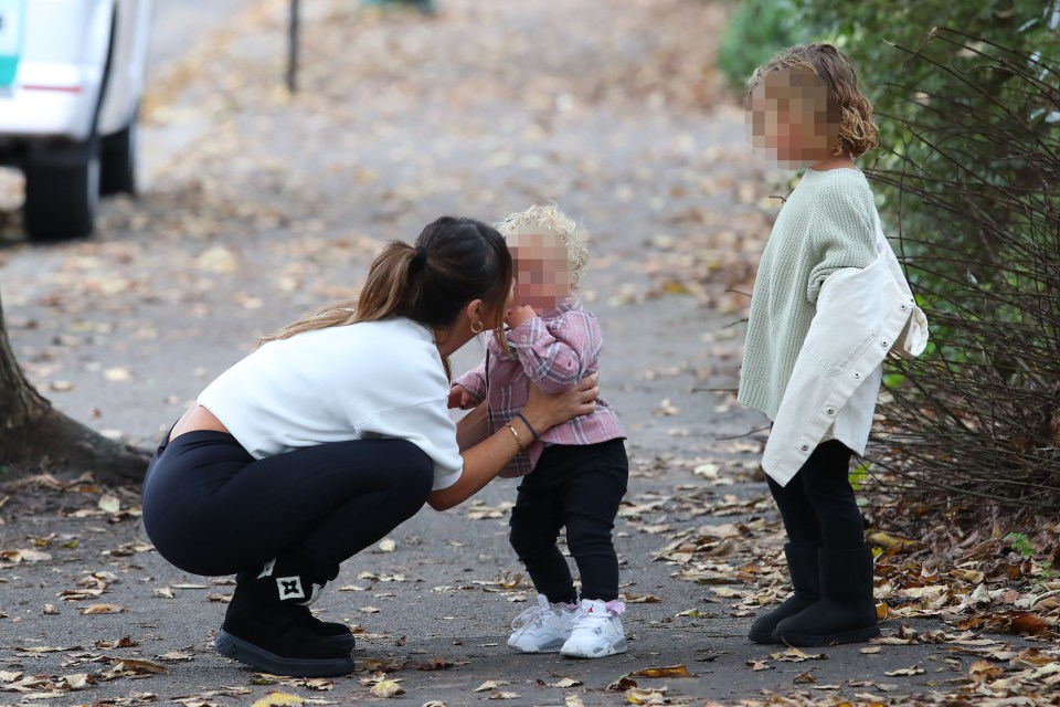 Lauryn Goodman walking with her two children.