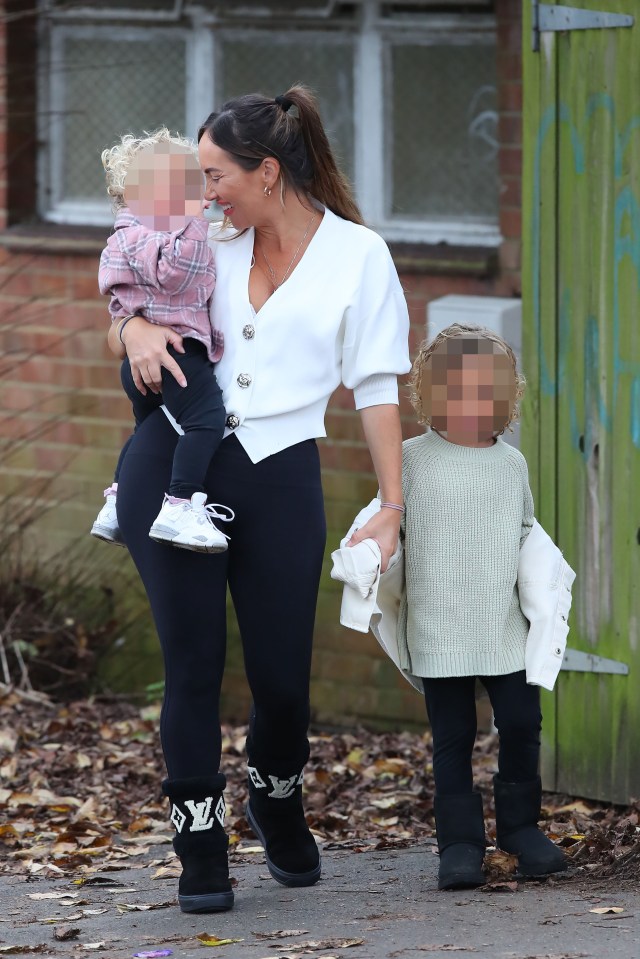 Lauryn Goodman walking with her two children.