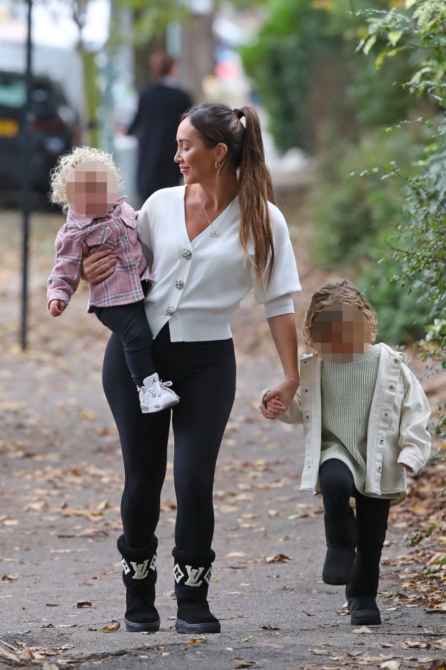 Lauryn Goodman walking with her two children.