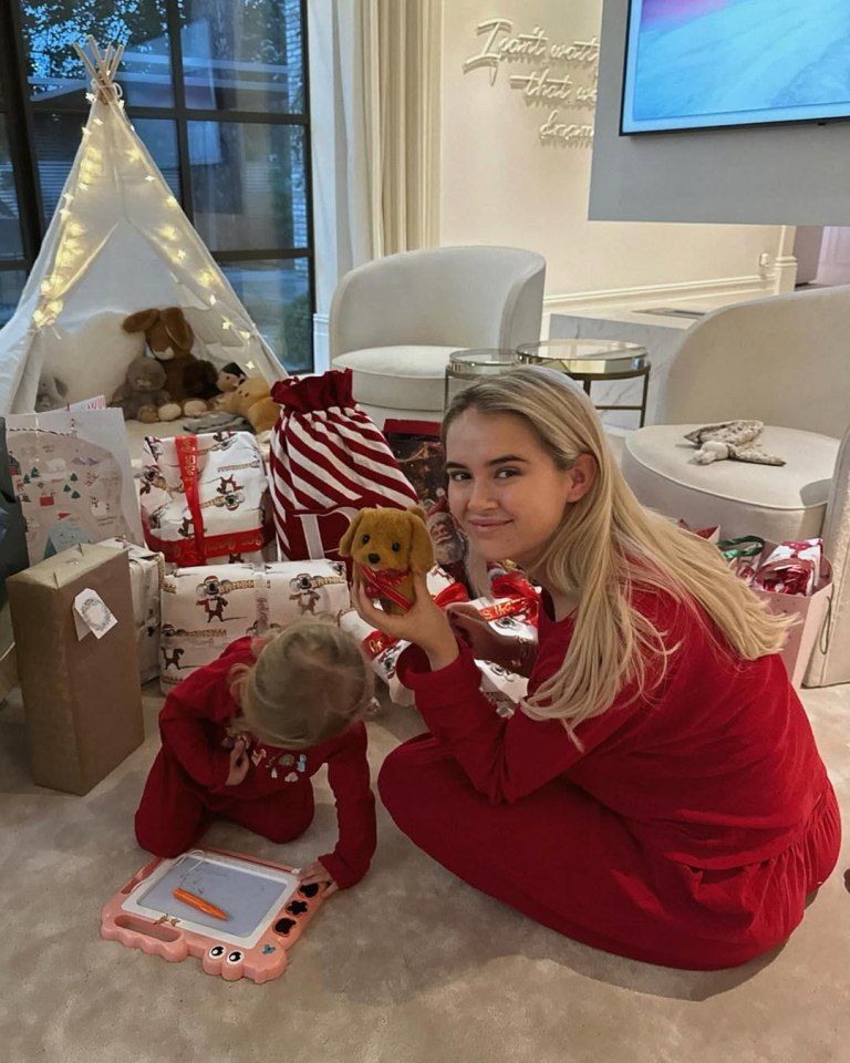 Molly-Mae and her daughter in matching red pajamas on Christmas Day, surrounded by presents.