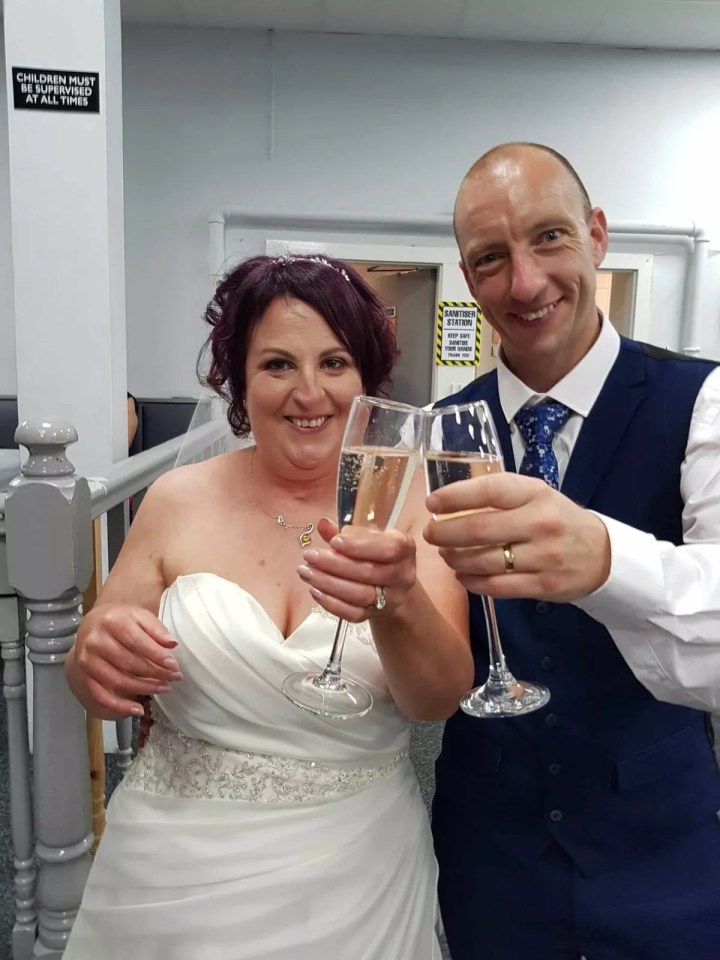 Bride and groom toasting with champagne flutes.