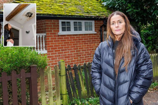 Woman stands outside a brick building with water damage to the ceiling inside.