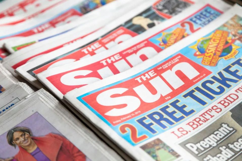 A stack of The Sun newspapers.