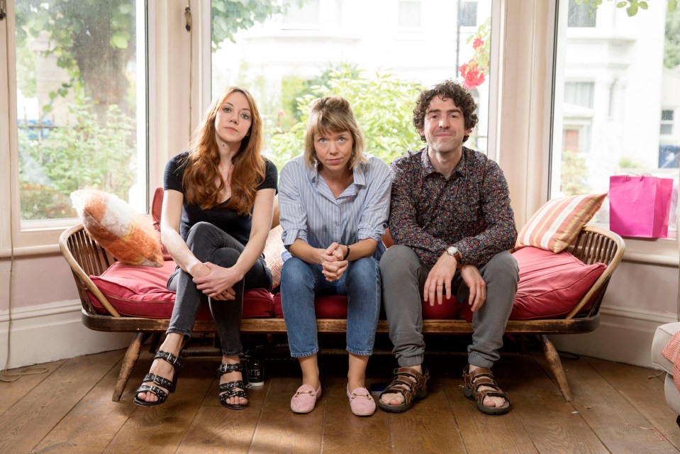 Three actors from the TV show *Motherland* sit on a couch.