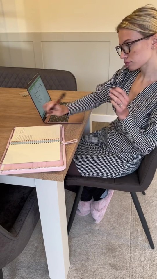 Woman working at a table with a laptop and planner.