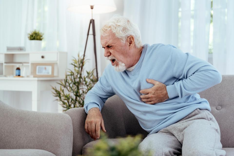 Senior man experiencing chest pain.