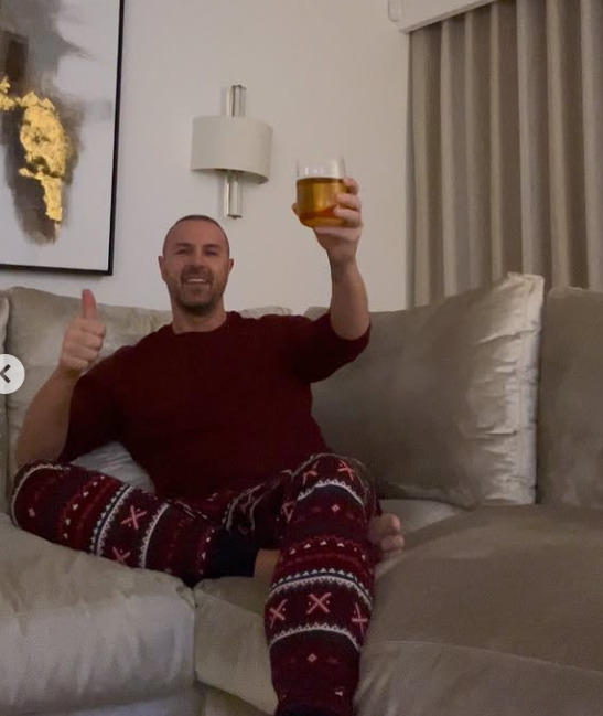 Paddy McGuinness on Christmas Day, giving a thumbs-up and holding a drink.