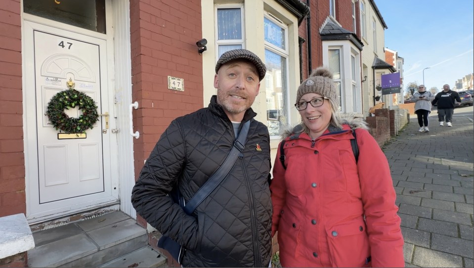 Paul Williams and Zoe Carlo stand outside a house in Barry, Wales.