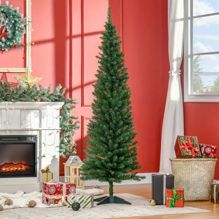 Slim artificial Christmas tree in a room with gifts.