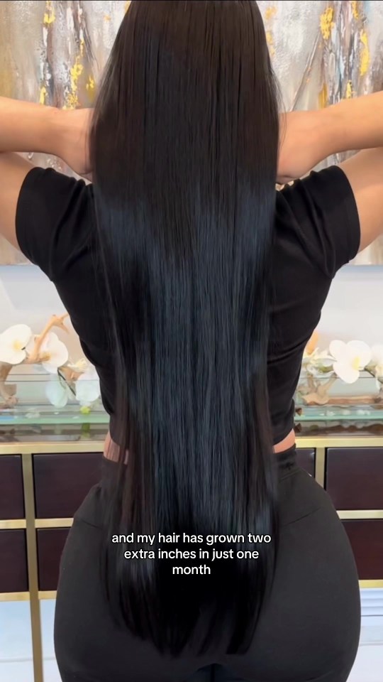 Woman showing off her long, thick hair that grew two inches in one month.