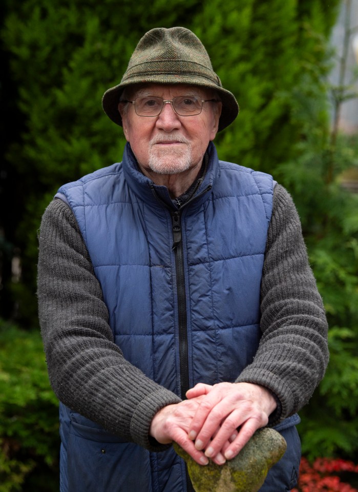 Phil Austin, builder of a lighthouse in Manchester, stands outdoors.