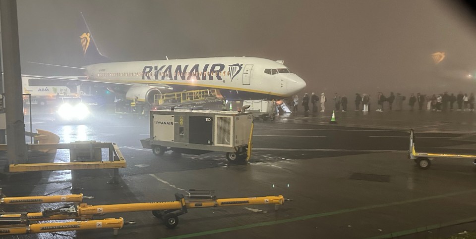 A Ryanair plane shrouded in fog at the airport