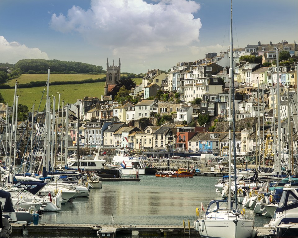 Brixham harbor with many boats and colorful buildings.