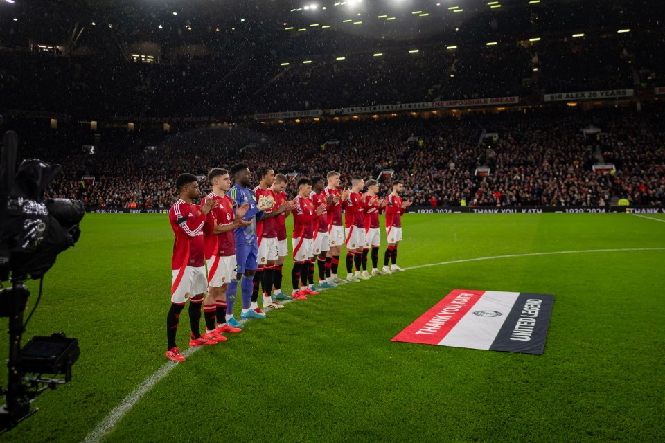 Players and staff of take part in a minute's silence