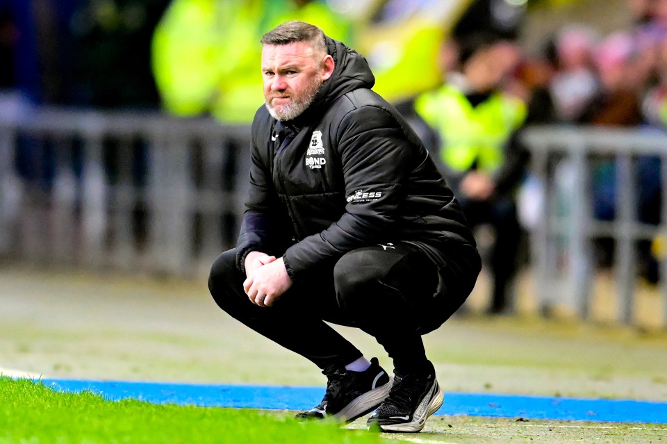 Rooney, 39, looked glum as he watched his team lose 2-0 against Oxford United yesterday