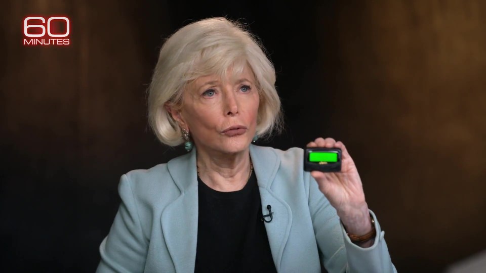 A woman on 60 Minutes holds up a pager.