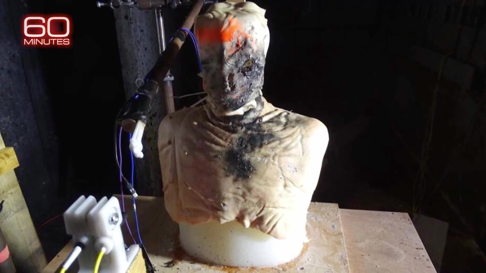 Burned mannequin torso used in demonstration of explosive device.