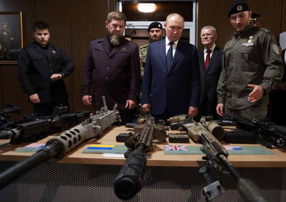 The Russian duo inspect Nato weaponry stolen by Russian troops during the war