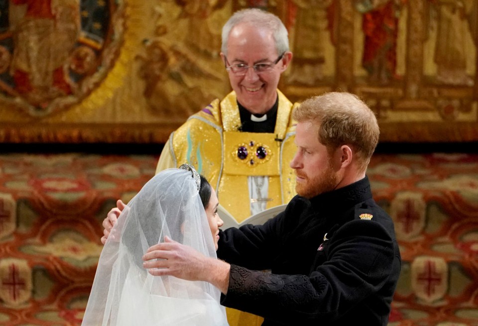 Harry removes Meghan's veil during the service