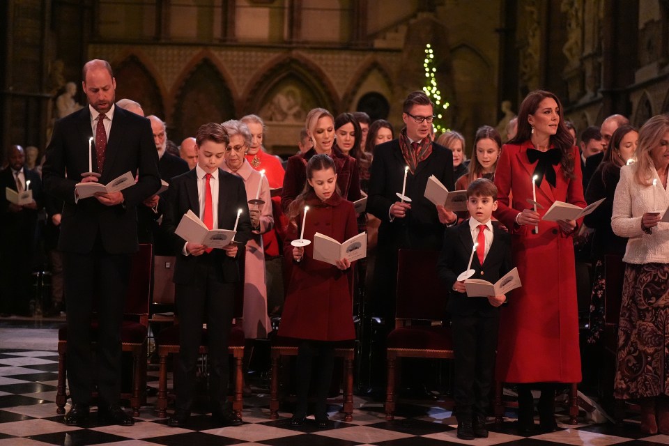 Kate and Wills standing either side of their brood as they sing festive carols