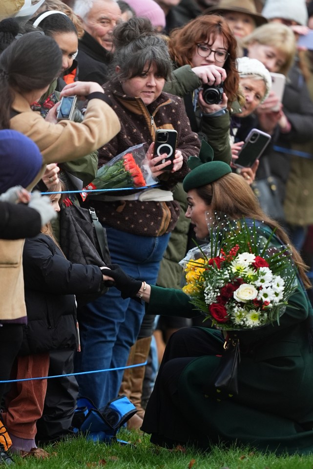 The Princess knelt down to greet one of the children spectating the morning church service from outside