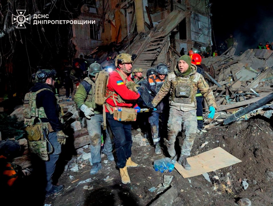 Rescuers at the site where an apartment building was hit by a Russian missile strike