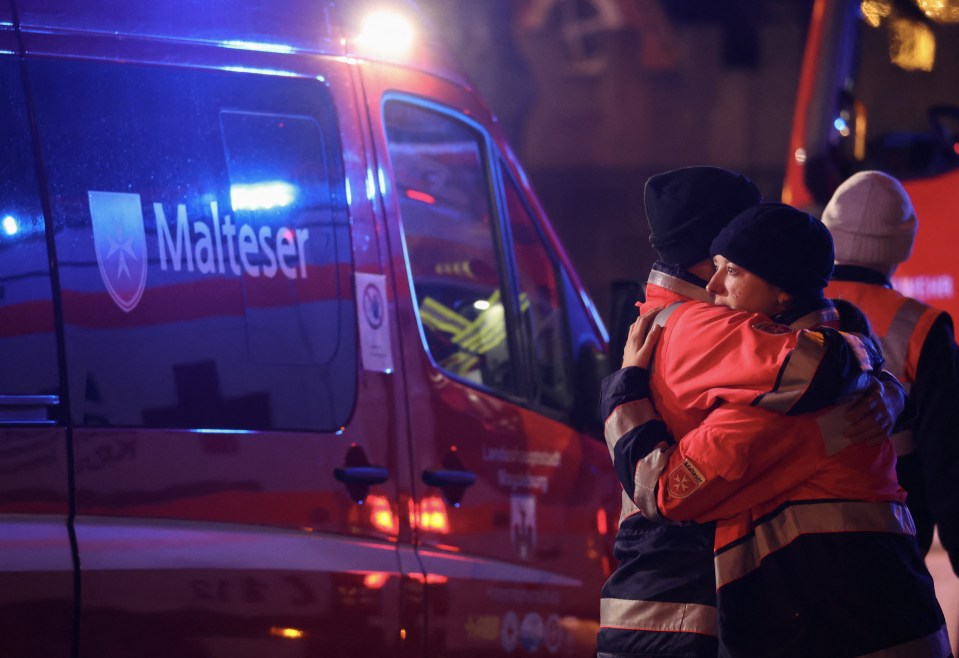 Rescue teams hug following the horror crash