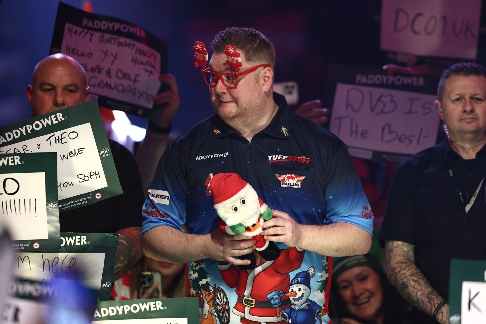 Ricky Evans of England enters the arena at the World Darts Championship.