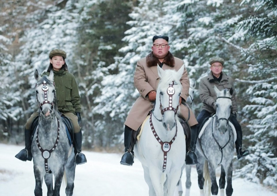 Kim, centre, rides a white horse up snow-covered Mount Paektu