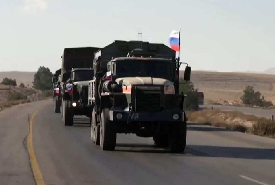 Scores of Russian military trucks waving flags were seen leaving Syria