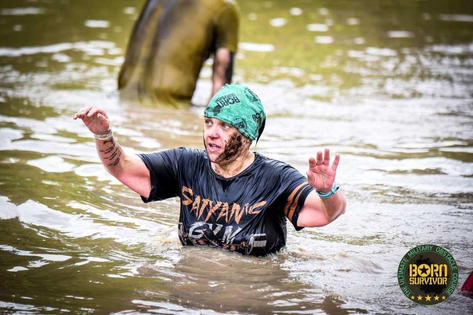 Woman participating in a mud race.