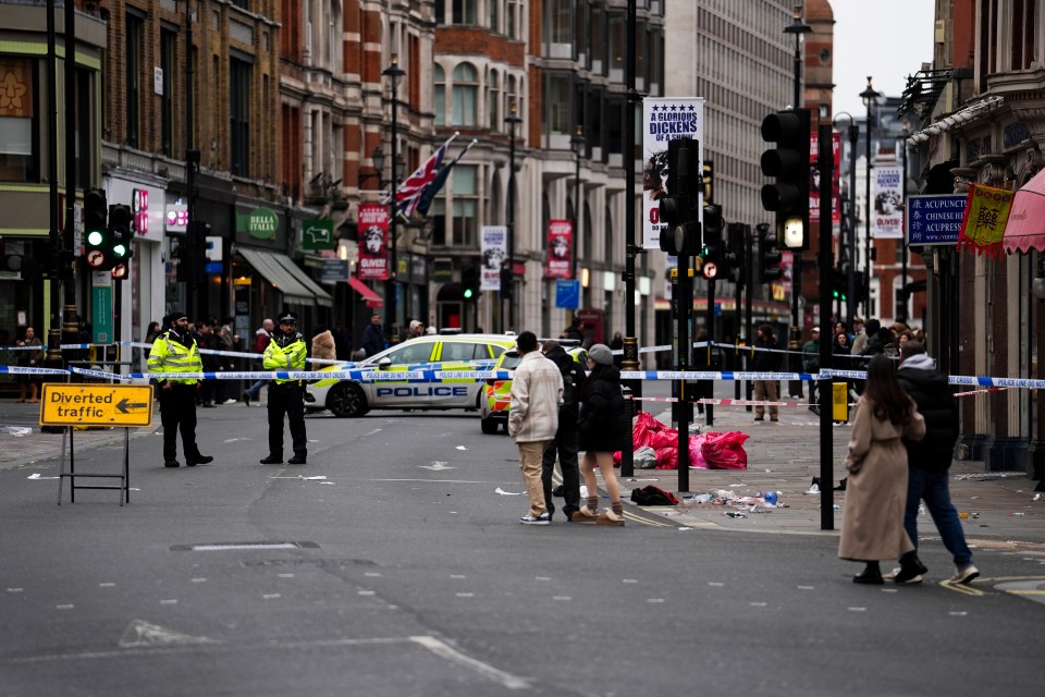 Crime scene on Shaftesbury Avenue in London, with police and barriers.