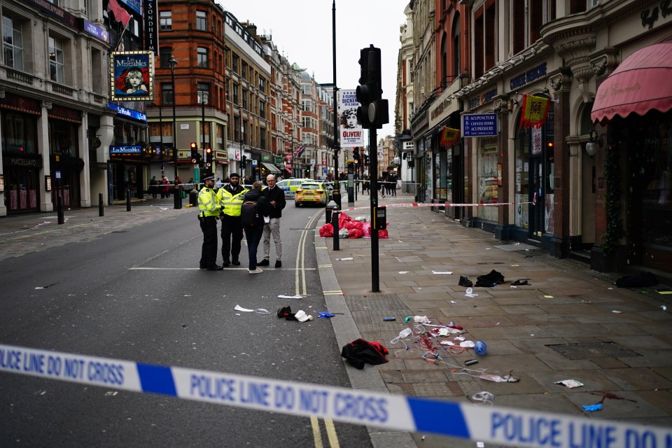 Crime scene on Shaftesbury Avenue in London; police officers at the scene.