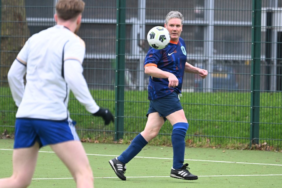 Keir Starmer playing football.