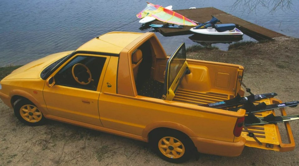 Yellow Skoda Felicia Fun pickup truck with water skis in the truck bed.