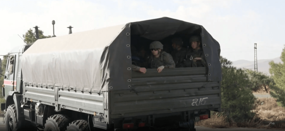 Russian troops bundled inside trucks leaving Syria