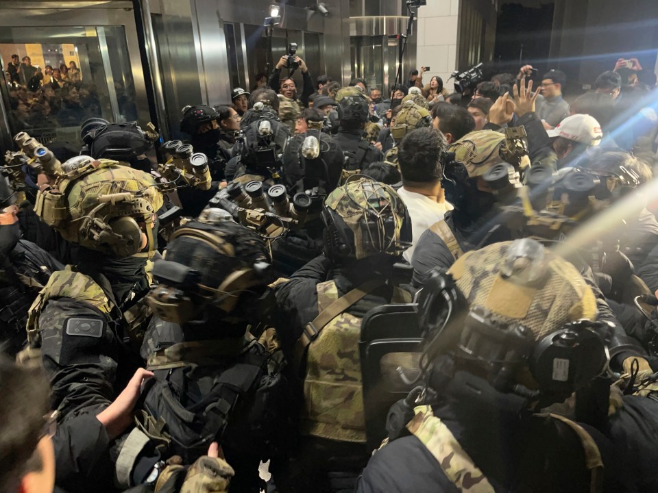 South Korean martial law soldiers try to enter the National Assembly compound in Seoul