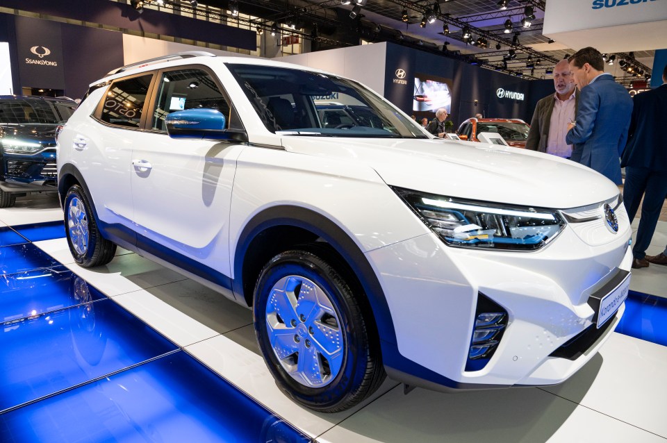 White SsangYong Korando e-Motion electric SUV on display.