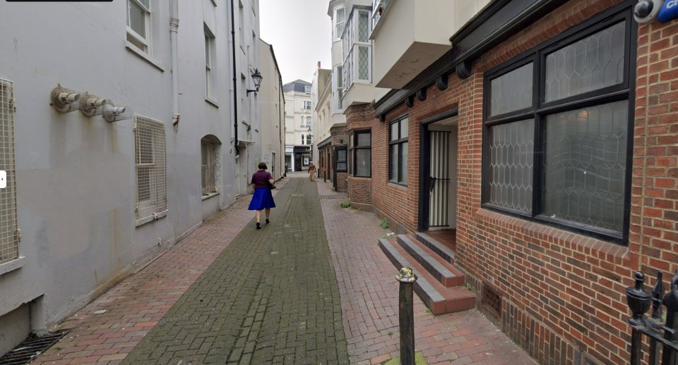 Woman walking down Steine Lane in Brighton.