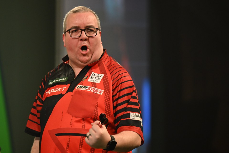 Stephen Bunting celebrates winning a darts match.