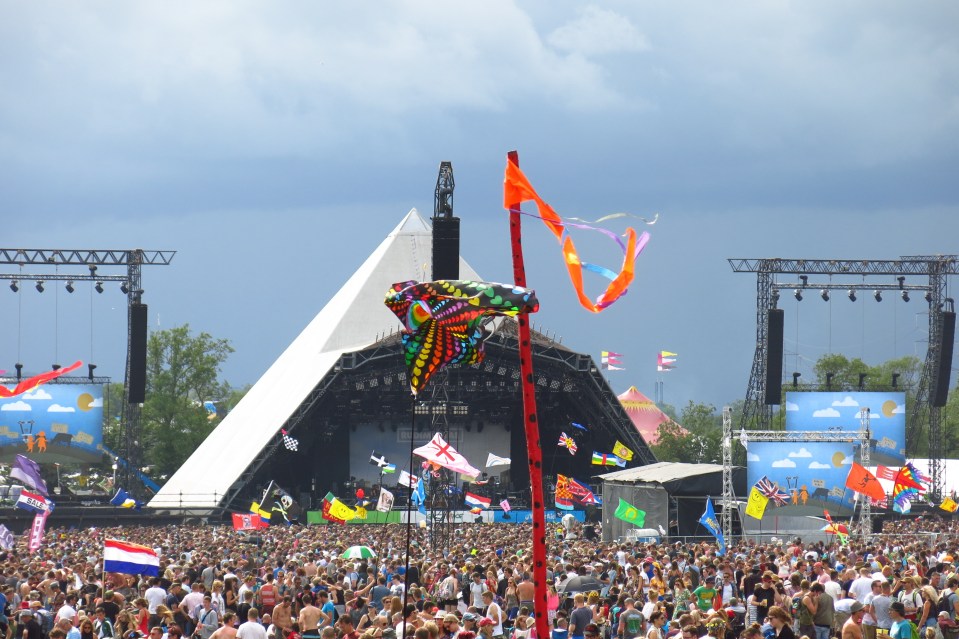 Large crowd at Glastonbury Festival in front of the Pyramid Stage.