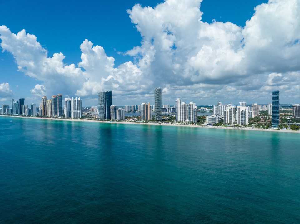 Aerial view of Miami Beach high-rises and ocean.