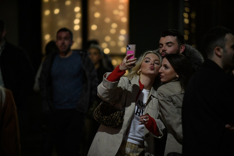 Three friends pose for a festive selfie in Manchester