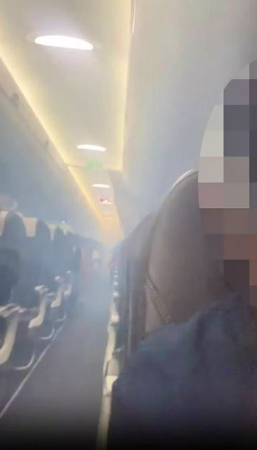 Smoke filling airplane cabin.